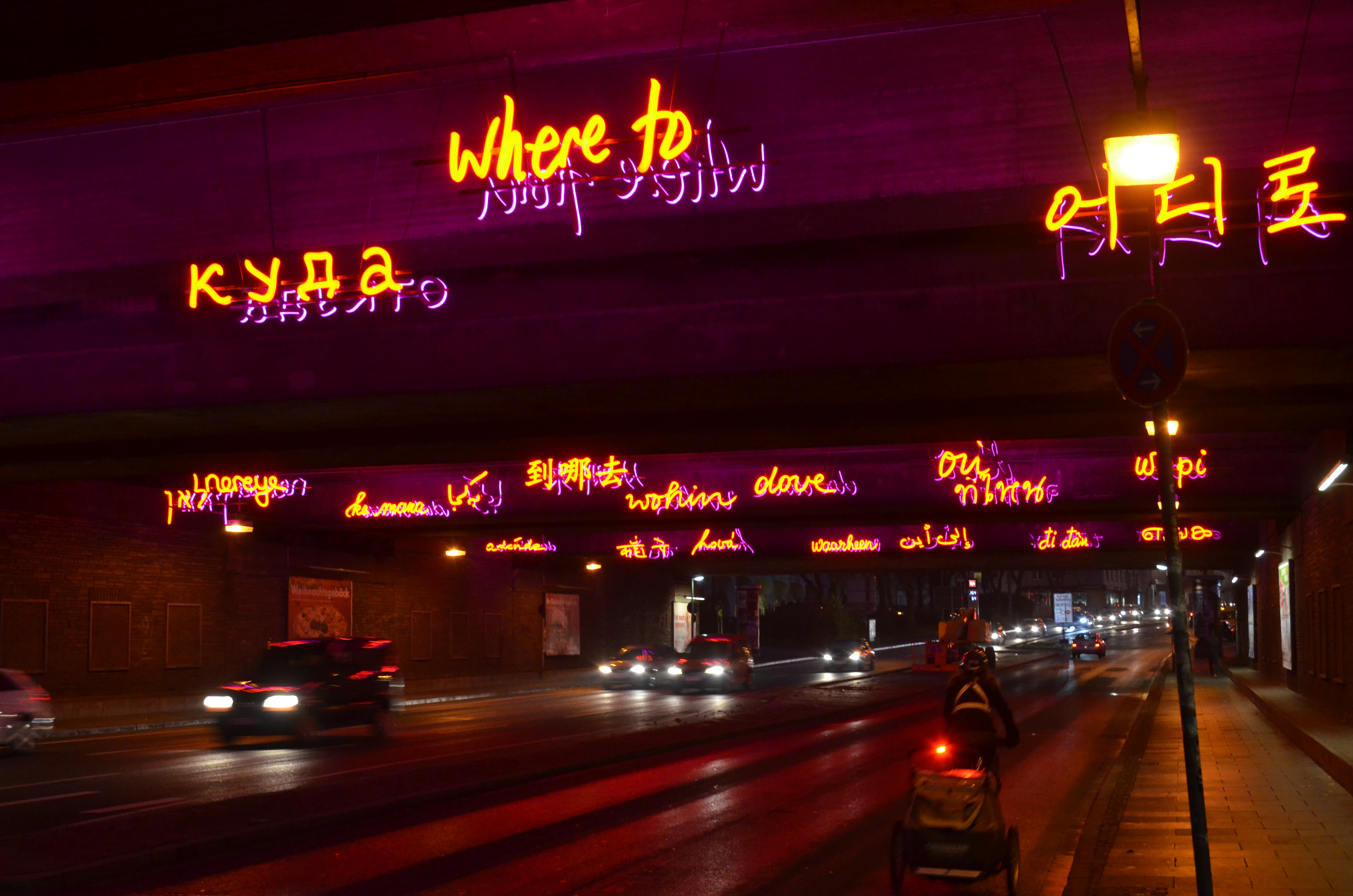 View of a tunnel at Bochum main station Neon signs with welcoming texts in several languages in focus