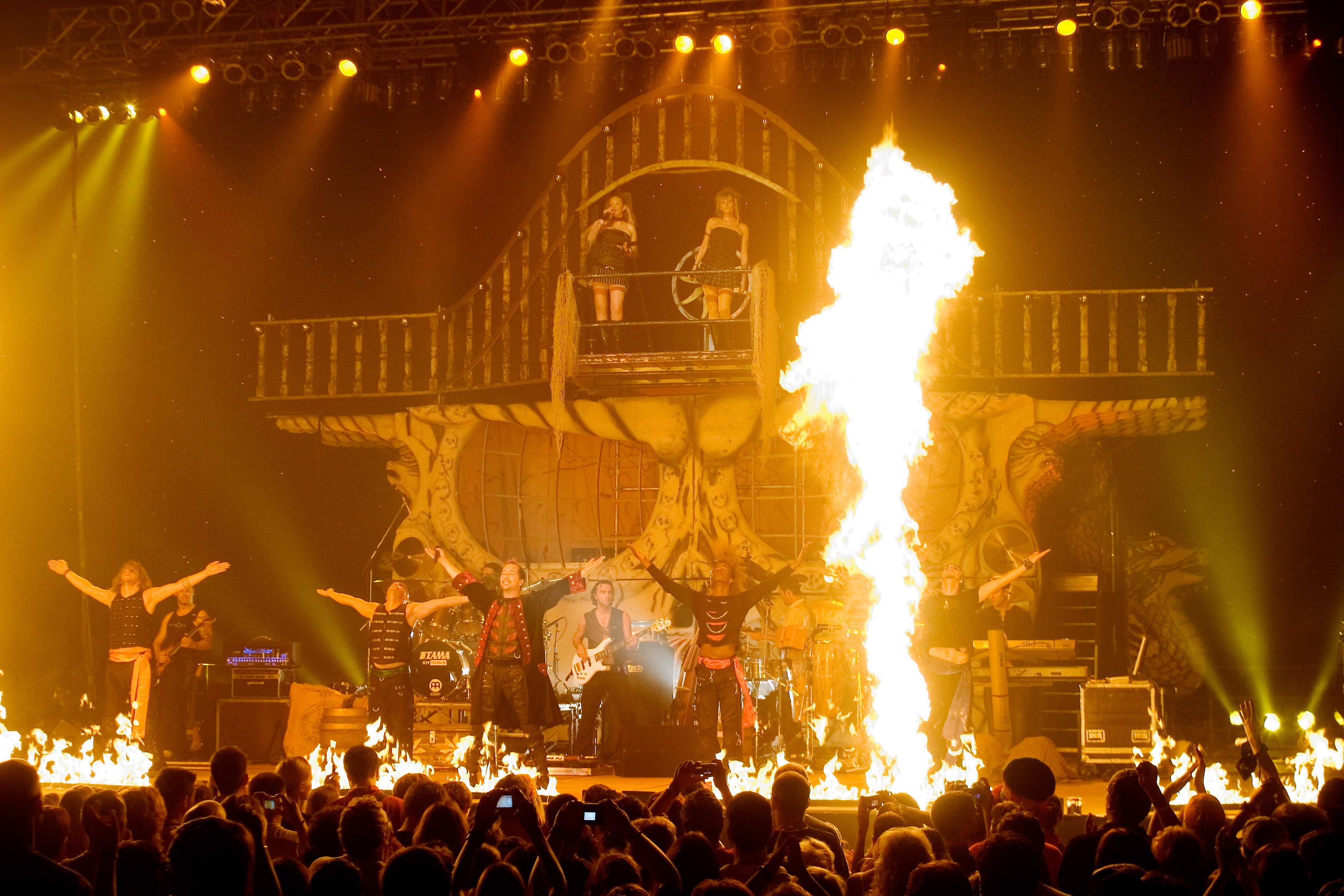 Big stage with performers and fire and lighting during a show